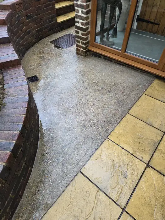 Clean patio with exposed aggregate concrete and york stone