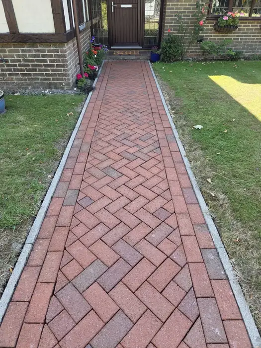 Clean bright herringbone brick path after pressure washing
